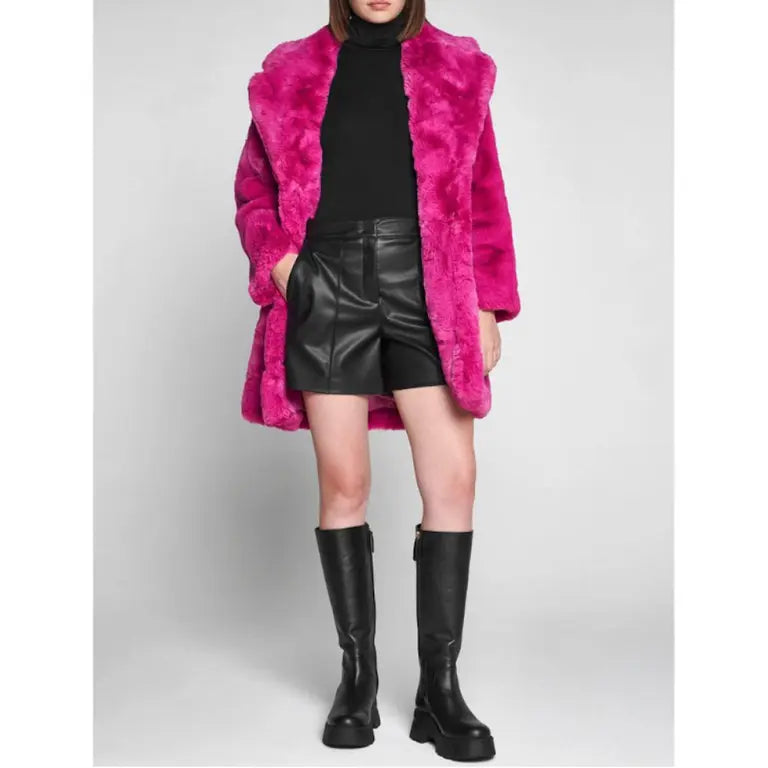 Apparis Women's Fashion Jacket in bright pink faux fur styled with black turtleneck and leather shorts