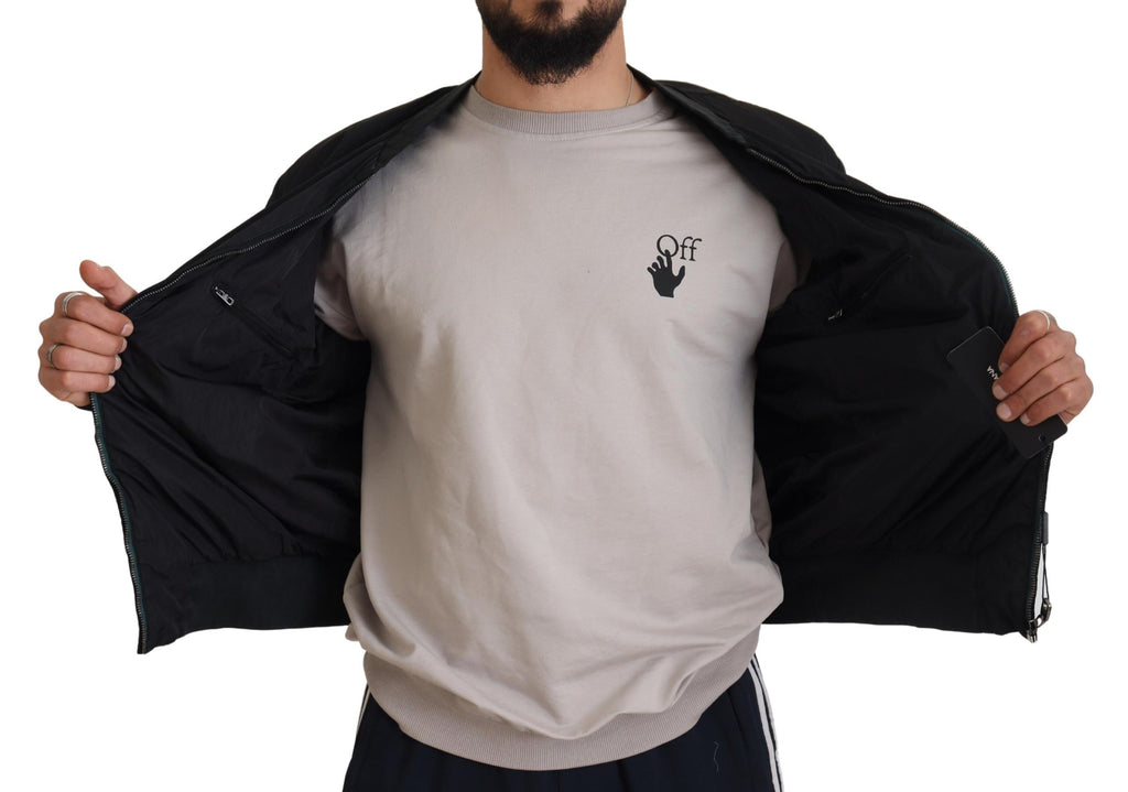 Man showing inside view of Dolce & Gabbana black bomber jacket with zip pockets and smooth lining