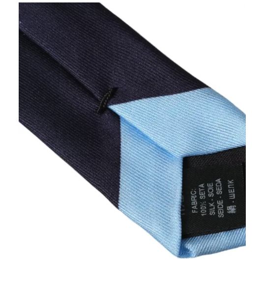 Close-up of Dolce & Gabbana silk tie showing fabric texture and label in navy and light blue colors