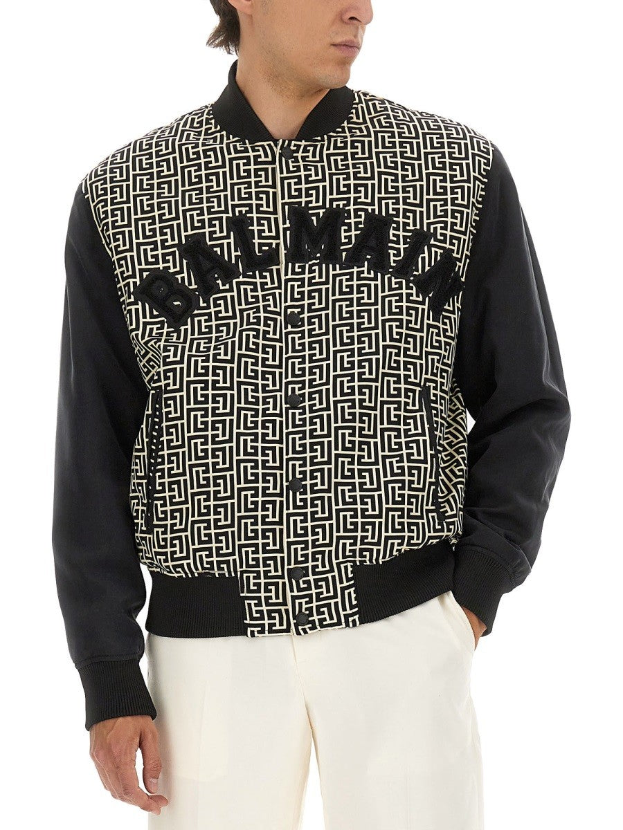 Balmain MONOGRAMMED VARSITY JACKET WITH PATCHES