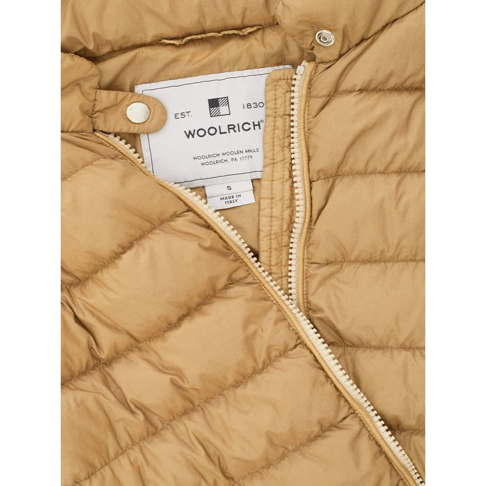 Close-up of Woolrich outdoor jacket beige quilted fabric with zipper and label inside